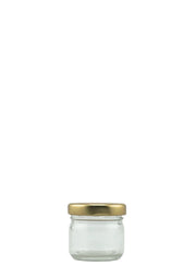 Petit bocal en verre transparent avec couvercle doré, idéal pour conserves ou présentation